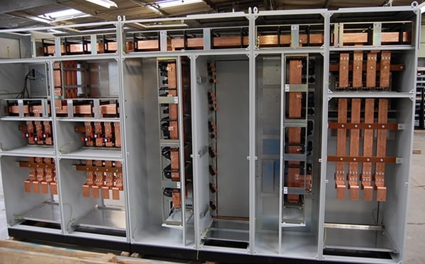 What is the role of a busbar in a panelboard?